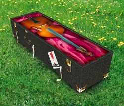 Coffin on grass painted with a picture of cello on front
